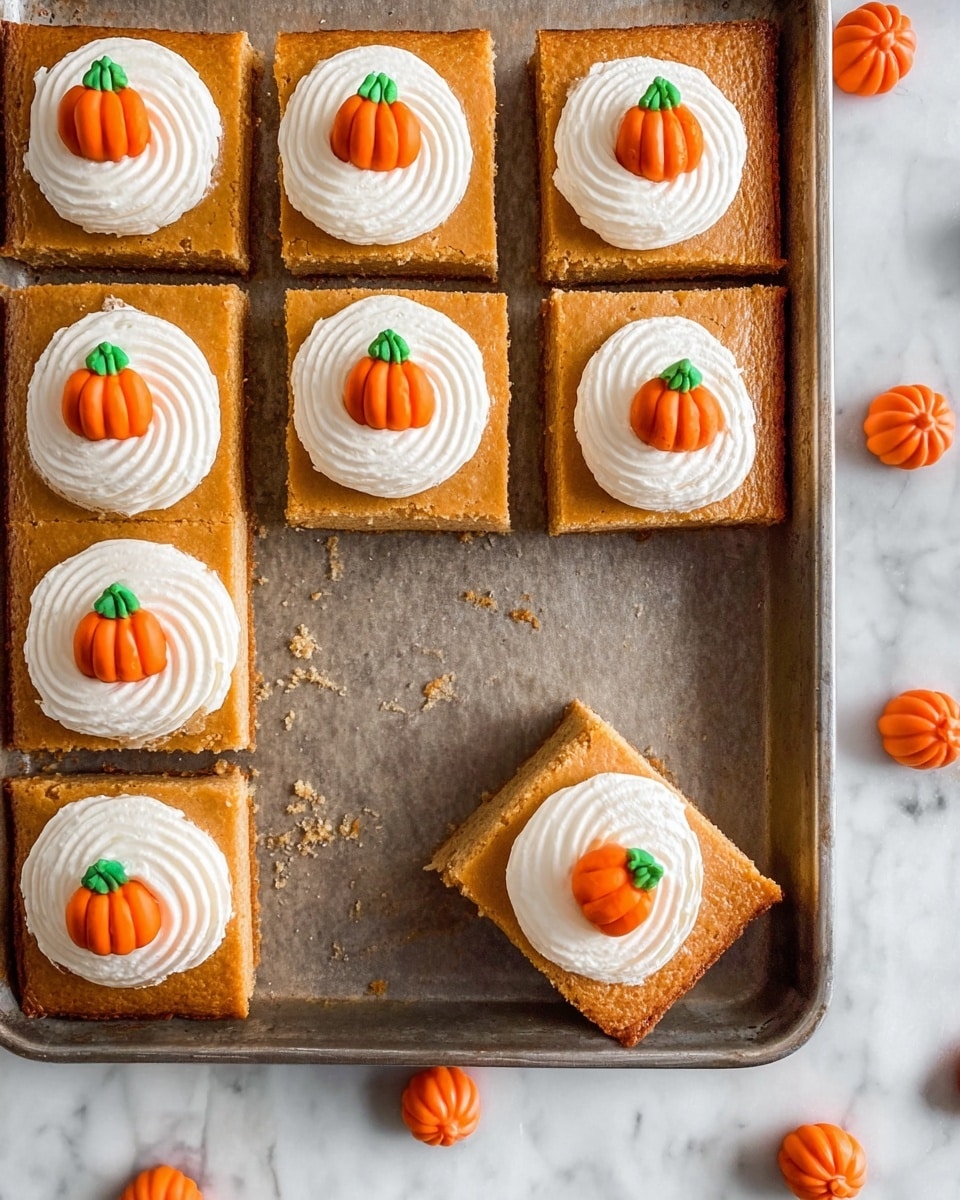 A metal baking tray on a white marbled surface holds a pumpkin-colored baked dessert cut into eight square pieces, with one piece slightly removed and angled in the bottom right corner. Each square piece has a thick, smooth pumpkin-colored base layer, topped with a swirl of white whipped cream in the center. At the peak of each whipped cream swirl is a small decorative orange pumpkin with a green stem made from icing. Several similar small orange pumpkin candies surround the tray on the marbled surface. photo taken with an iphone --ar 4:5 --v 7