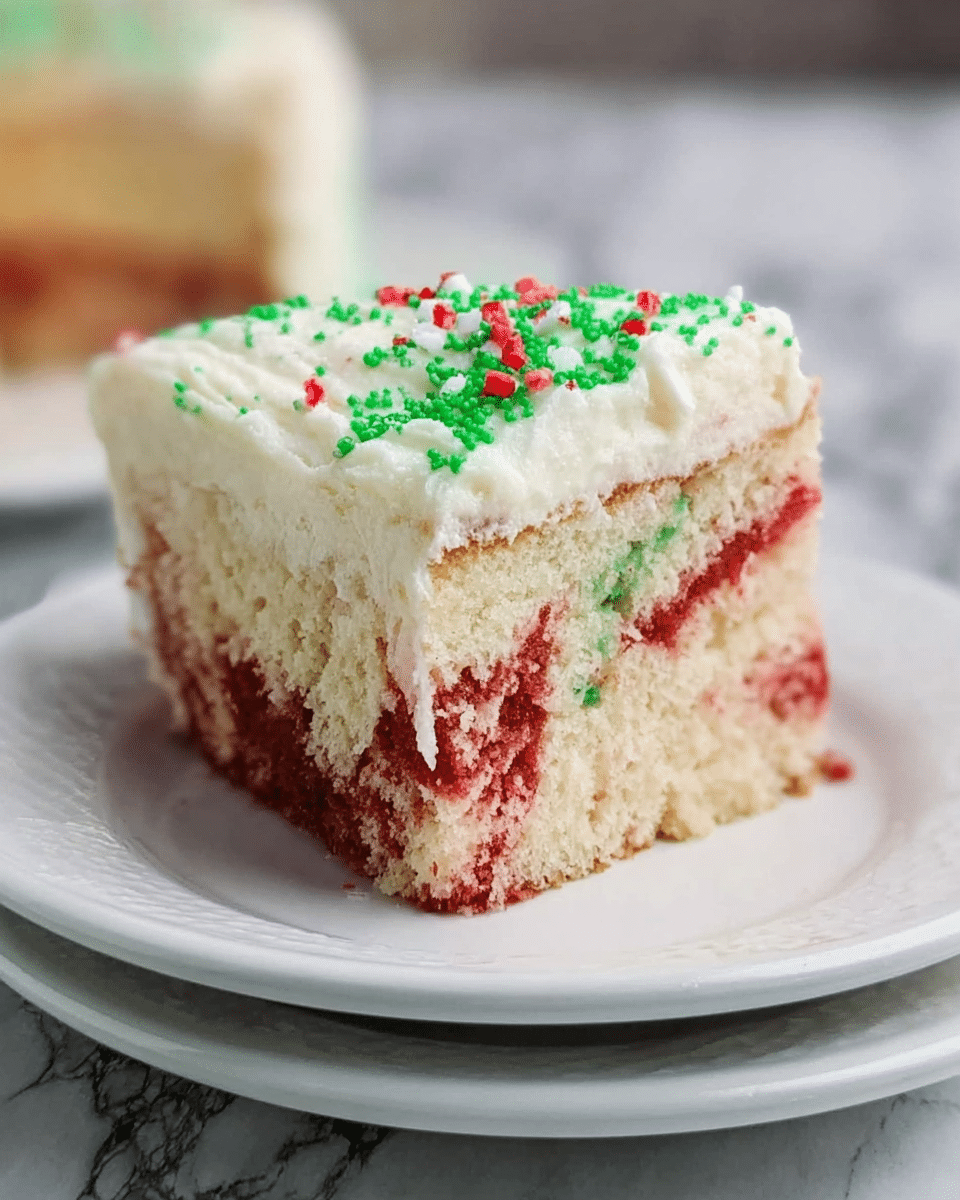 A single piece of cake with two layers is shown on a stack of two white plates on a white marbled surface. The bottom layer is a moist, swirled mix of red and white cake with a soft texture. The top layer is thick white frosting with a smooth, creamy look, sprinkled with small green and red decorations. The cake piece has a clean cut, showing the color contrast clearly. Photo taken with an iphone --ar 4:5 --v 7
