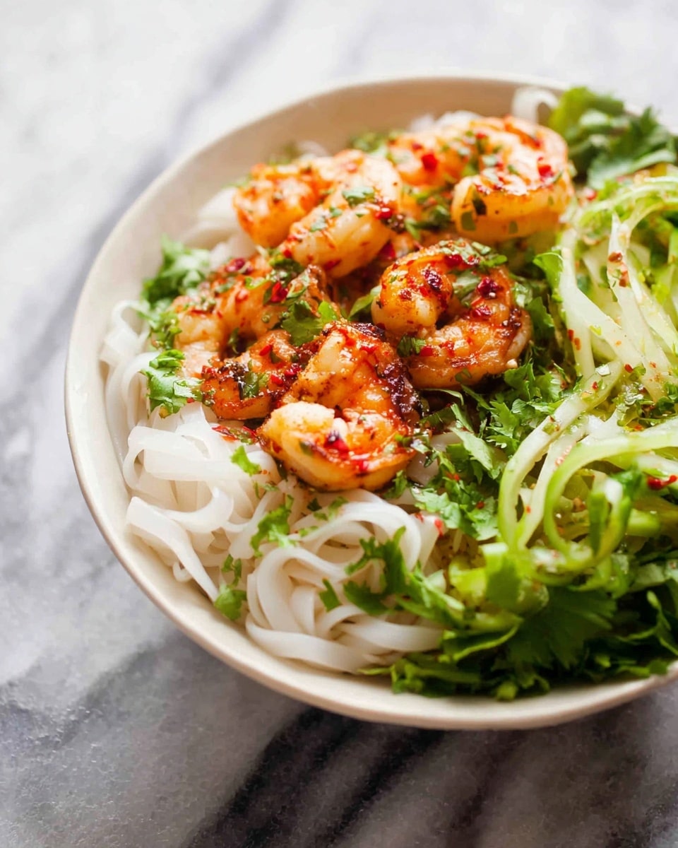 A white bowl holds a layered dish with three main parts: on the left, there is a nest of soft, white thin noodles with a smooth, slightly shiny texture; in the middle, several grilled shrimp are placed on top, they are orange with some red flecks and a charred look, showing their crispy texture; on the right, a pile of green, thinly sliced vegetables adds a fresh, crunchy layer with a quick touch of herbs scattered over everything. The background is a white marbled surface, giving a clean and simple look. Photo taken with an iphone --ar 4:5 --v 7