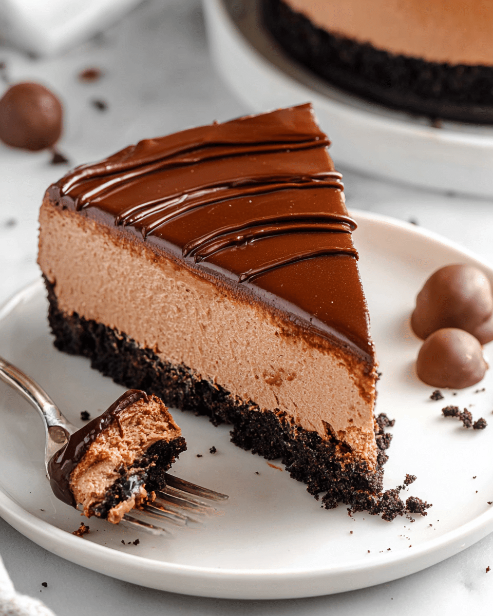 A slice of chocolate mousse pie is shown on a white plate placed on a white marbled surface. The pie has three visible layers: a dark, crumbly chocolate cookie crust at the bottom, a thick, light brown creamy chocolate mousse filling in the middle with a smooth texture, and a glossy, dark chocolate ganache layer on top with subtle wavy patterns. A silver fork holds a small bite-sized piece showing all three layers with the crust attached. A few chocolate-covered treats and crumbs are scattered around the plate. Photo taken with an iphone --ar 4:5 --v 7