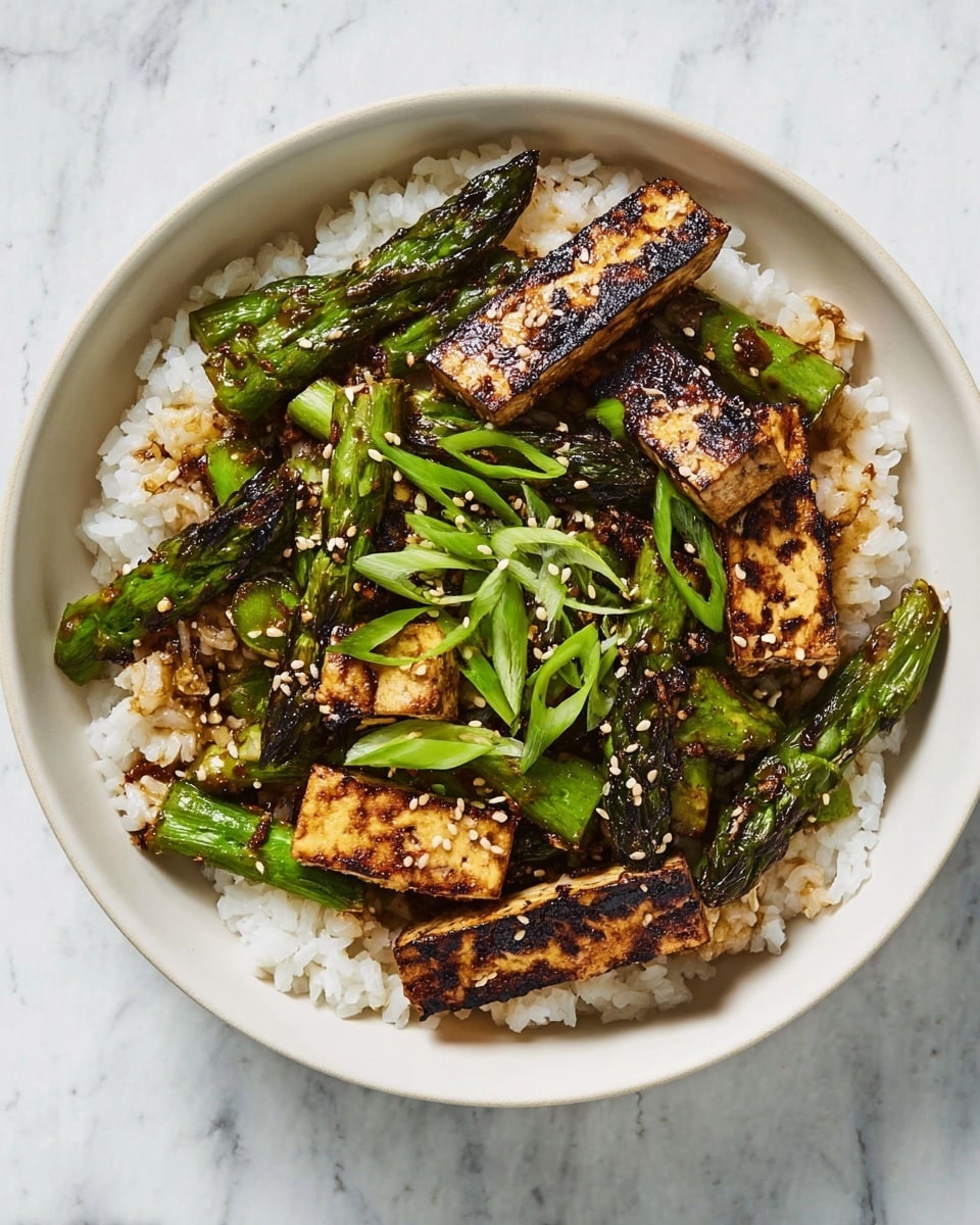 A white bowl filled with a base layer of fluffy white rice with a soft texture, topped with a second layer of grilled green asparagus pieces that have a slightly charred look and glossy surface, mixed with thick, rectangular slices of browned tofu showing dark grill marks and a firm texture. The dish is garnished with thin, bright green, curled slices of spring onions and sprinkled with small, light brown sesame seeds. The bowl sits on a white marbled surface. photo taken with an iphone --ar 4:5 --v 7