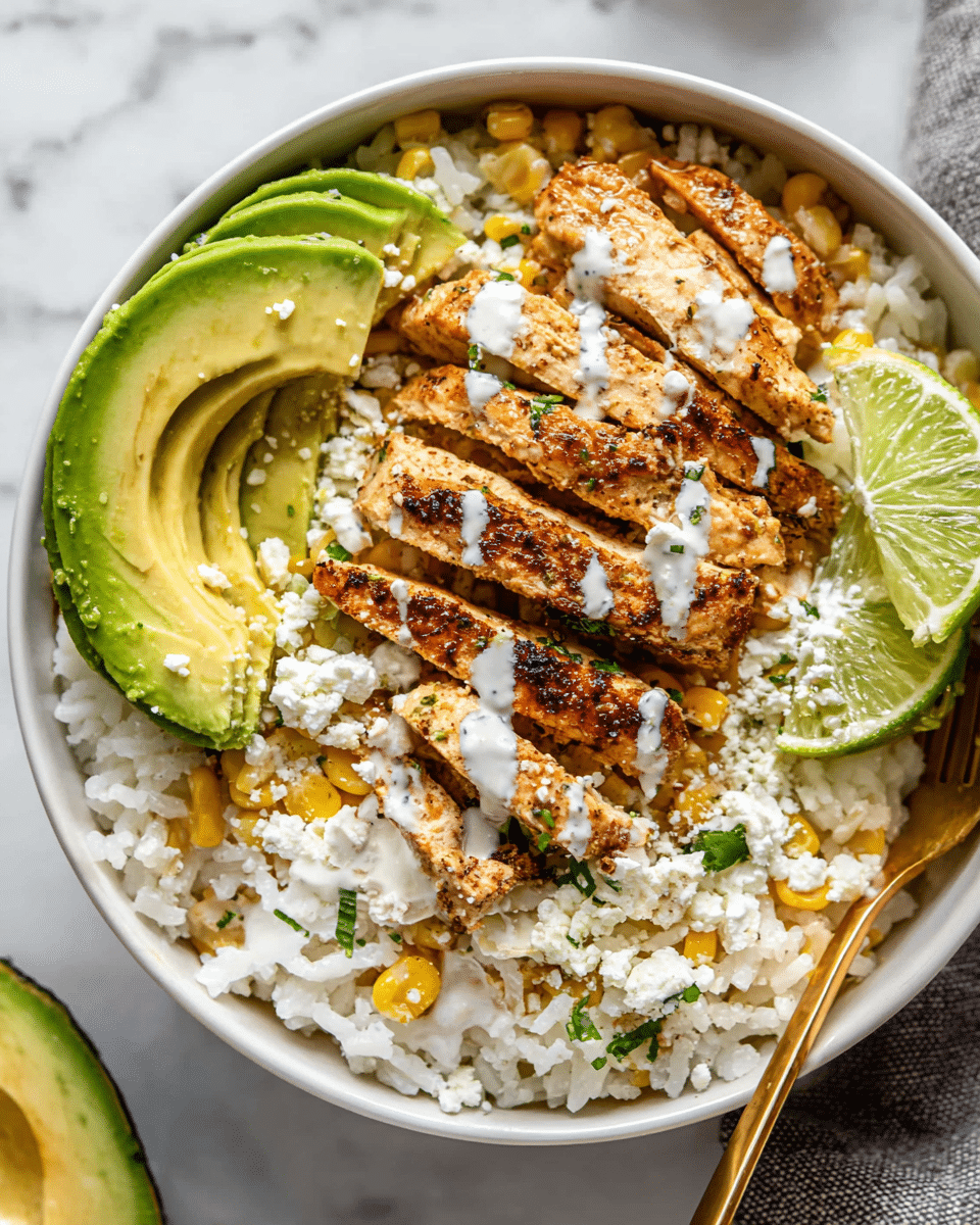 A white bowl filled with a layered dish starting at the bottom with white rice mixed with yellow corn. On top, golden brown grilled chicken strips are neatly placed in the center. Two slices of green avocado are arranged on the left edge of the bowl, and two lime wedges rest on the right side. Crumbled white cheese is sprinkled over the chicken and rice, with small green herb pieces scattered around. A white creamy sauce is drizzled lightly on the avocado and chicken. The bowl sits on a white marbled surface, with a gold fork partially inside the bowl on the right. Photo taken with an iphone --ar 4:5 --v 7