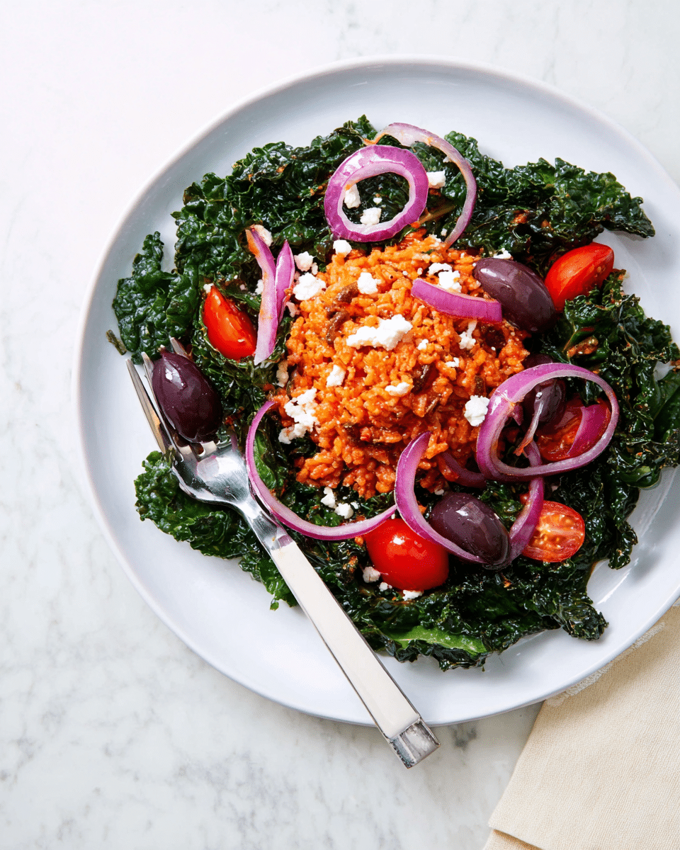 A white plate holds a colorful dish starting with a base layer of dark green kale leaves spread out around the plate’s edge. On top, there is a mound of reddish-orange seasoned rice that covers the center of the kale. Scattered over the rice and kale are thin purple rings of red onion, small chunks of white feta cheese, and halved dark purple Kalamata olives. Bright red cherry tomato halves are placed around the rice for color and freshness. A silver fork with a white handle rests on the edge of the plate, holding one dark purple olive. The plate sits on a white marbled surface, creating a clean and fresh background. Photo taken with an iphone --ar 4:5 --v 7