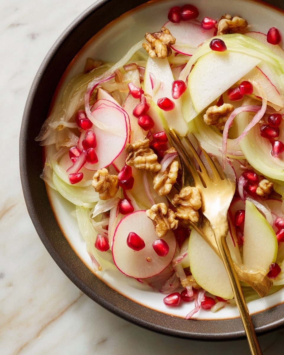 The image shows a close-up of a salad in a white bowl with a dark rim, set on a white marbled surface. The salad has several thin layers including pale green slices of apple, translucent thin round slices of onion with a hint of pink, thin red radish slices, and small pieces of light brown walnuts scattered on top. There are also bright red pomegranate seeds dotted throughout the salad. A gold metal fork is placed inside the bowl, holding some onion and radish slices. The textures include the smoothness of the fruit and vegetables, the rough crunch of walnuts, and the shiny wetness of salad dressing. Photo taken with an iphone --ar 4:5 --v 7