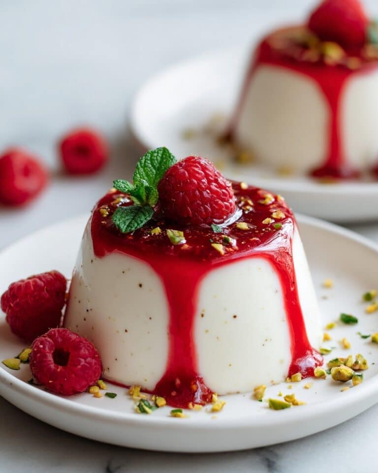 Creamy Vanilla Panna Cotta with Raspberry Coulis and Pistachio Topping Recipe