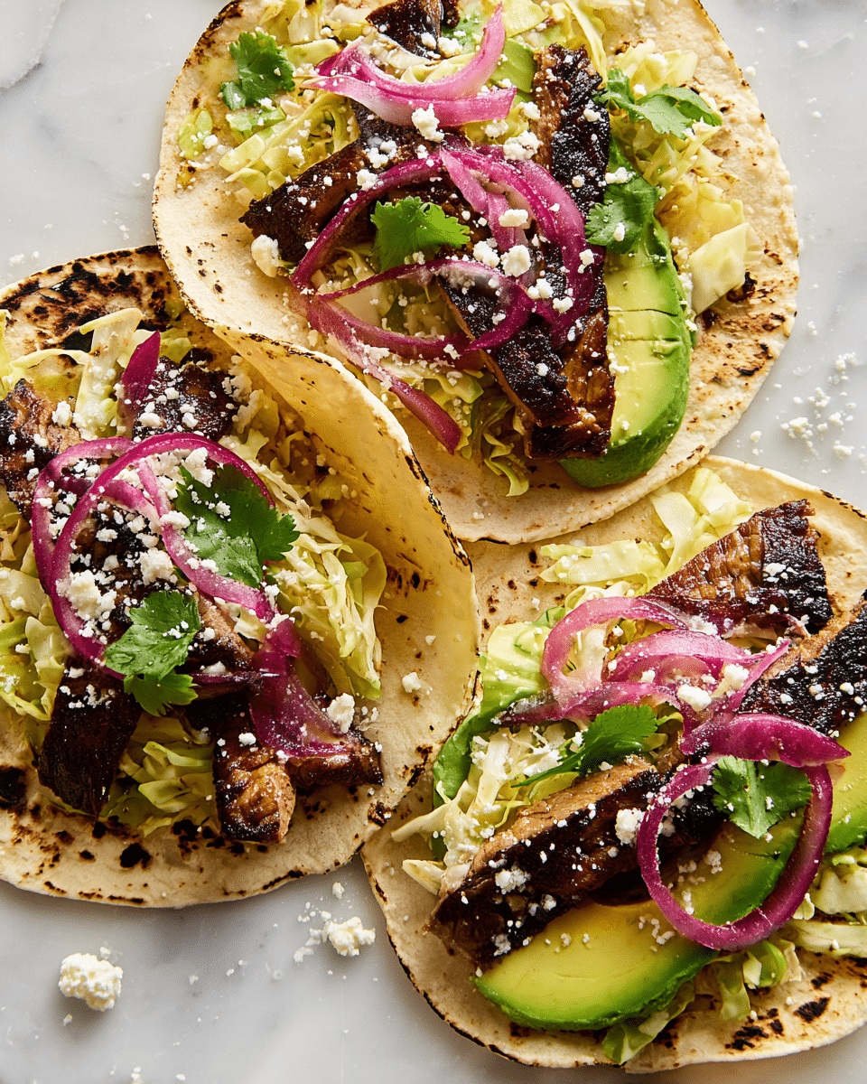 Three soft, white corn tortillas are laid out on a white marbled surface, each slightly charred at the edges. Each tortilla is topped with a green layer of sliced avocado at the bottom, followed by crispy, shredded pale yellow cabbage mixed with thin, round slices of reddish-purple pickled onions. On top of the cabbage sit several dark brown, grilled strips of meat with visible grill marks. Small green cilantro leaves are scattered across all layers, and a fine crumble of off-white cheese is sprinkled unevenly over the tacos and surrounding surface. Photo taken with an iphone --ar 4:5 --v 7