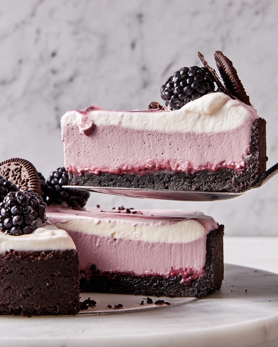 A slice of a three-layer tart is shown being lifted by a spoon from a whole tart. The bottom layer is a thick, dark chocolate crust with a rough texture. The middle layer is a smooth, thick, light purple mousse filling. The top layer is a thin, creamy light pink layer with some whipped cream on top, which is white with some purple streaks. The slice is decorated with a fresh, shiny black blackberry and a small piece of dark chocolate cookie. The whole tart below has similar toppings of blackberries, whipped cream, and cookie pieces. The background and surface have a white marbled texture. photo taken with an iphone --ar 4:5 --v 7