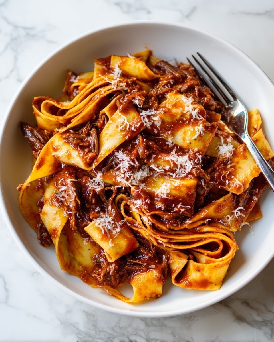 The dish shows wide, flat pasta noodles layered and folded in different directions, covered in a rich, dark brown meat sauce with visible shredded beef pieces. The sauce looks thick and clings well to the pasta, which has a golden-yellow color with a soft texture. Small shreds of white cheese are sprinkled on top, melting slightly into the sauce. A fork is placed on the right side, twisted with pasta and sauce. The white bowl sits on a white marbled surface, adding a clean and bright contrast to the warm colors of the pasta and sauce. photo taken with an iphone --ar 4:5 --v 7