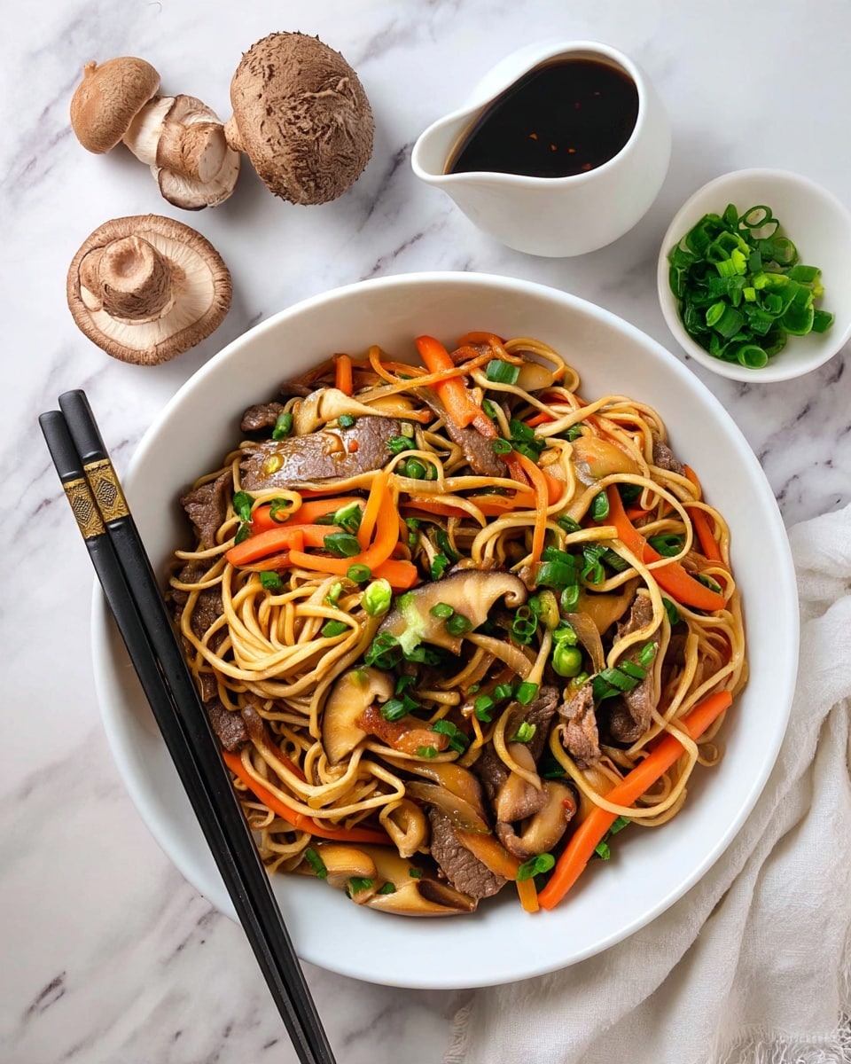 A deep white bowl filled with a colorful stir-fry of noodles, thin slices of browned beef, orange carrot sticks, and shiny brown mushroom pieces, all topped with bright green chopped scallions. The noodles are long and slightly twisted, spread throughout the bowl mixing well with the vegetables and beef. Two black chopsticks with gold accents rest on the left side of the bowl. Around the bowl, there are fresh whole mushrooms, a small white bowl of green scallions, a white ceramic sauce pourer with dark sauce, and a soft white cloth on a white marbled surface. photo taken with an iphone --ar 4:5 --v 7
