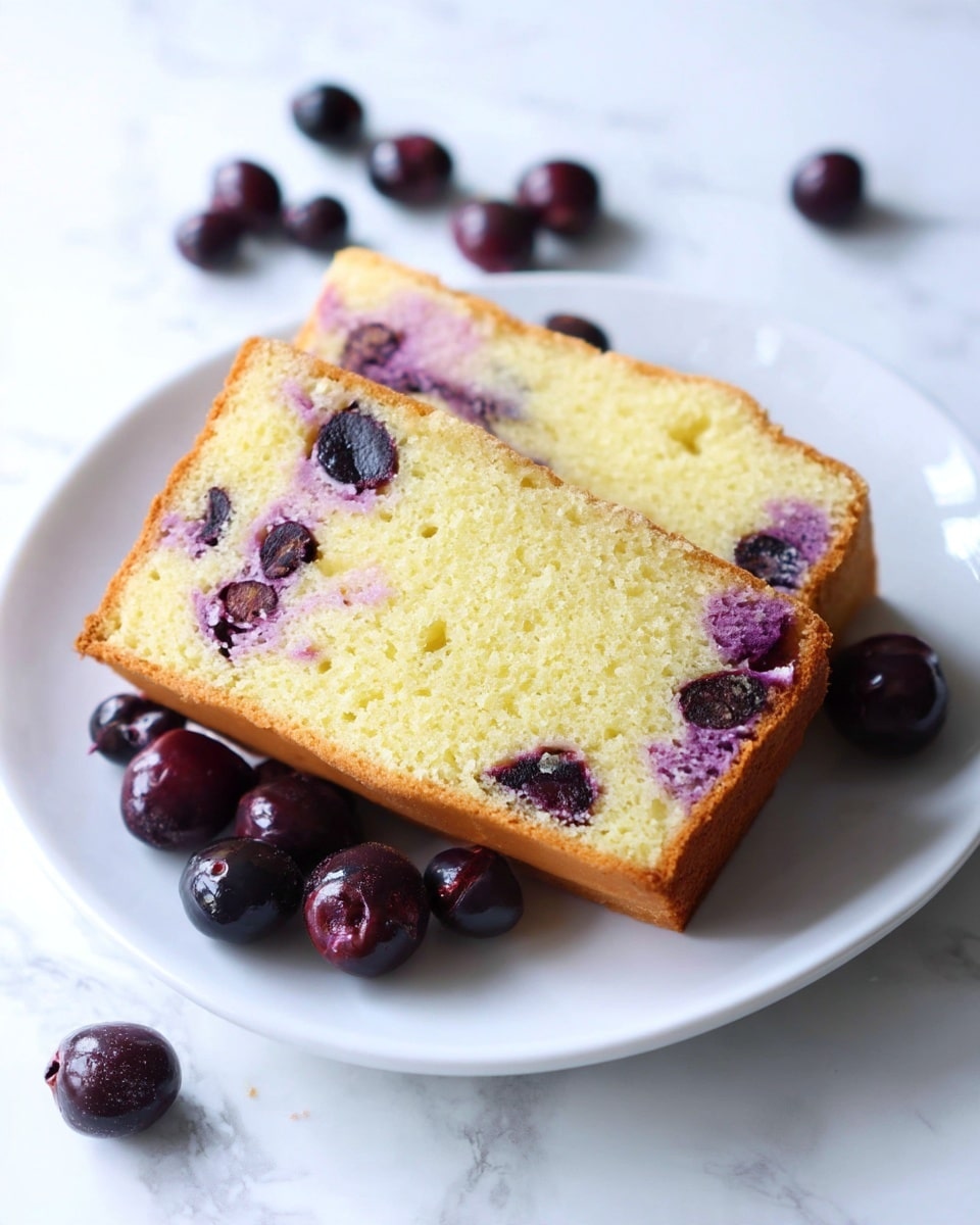 Two slices of light golden-brown cake with visible soft and fluffy texture are stacked on a white plate. Inside the cake, there are swirls of purple and pieces of dark purple berries embedded in the pale yellow crumb. Around the plate, several whole glossy dark purple berries with a shiny surface are scattered. The plate sits on a white marbled surface. photo taken with an iphone --ar 4:5 --v 7